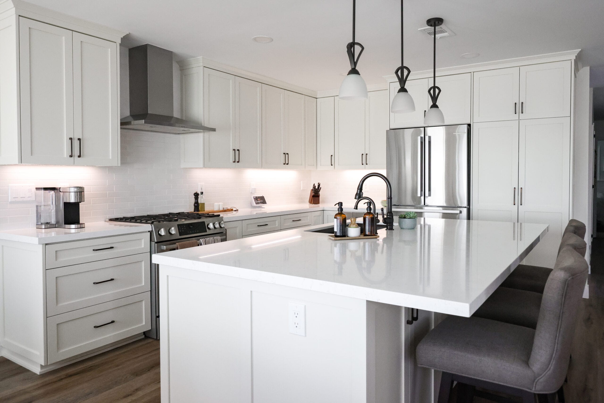 White shaker kitchen with a large island and subway tile backsplash